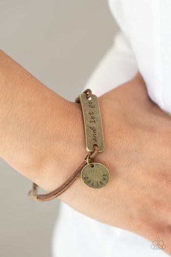 An antiqued disc stamped in the word, 