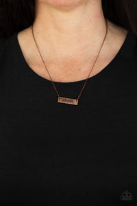 Stamped in the word, "Mama," a rectangular copper plate is suspended below the collar by a dainty copper chain, creating a whimsy inspirational pendant. Features an adjustable clasp closure.  Sold as one individual necklace. Includes one pair of matching earrings.