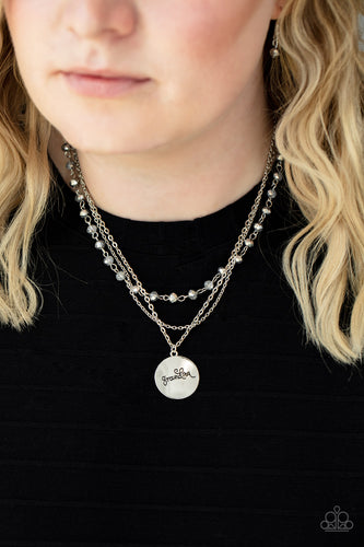Infused with a strand of metallic flecked hematite crystal-like beads, two dainty rows of mismatched silver chains delicately layer below the collar. Stamped in the word, 