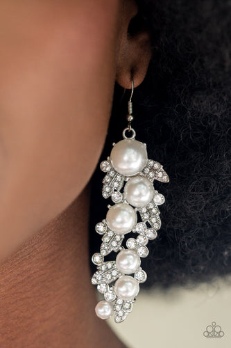 An explosion of glittery white rhinestones and oversized pearls coalesce into an exaggerated leafy silver lure, creating a dramatic statement piece. Earring attaches to a standard fishhook fitting.  Sold as one pair of earrings.