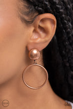 Load image into Gallery viewer, Brushed in an antiqued shimmer, a copper hoop swings from the bottom of an oversized copper stud for a classic metallic look. Earring attaches to a standard clip-on fitting.  Sold as one pair of clip-on earrings.
