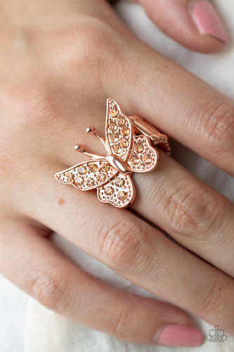 Encrusted in sparkly rhinestones, a shiny copper butterfly flutters atop the finger for an enchanting fashion. Features a stretchy band for a flexible fit.  Sold as one individual ring.