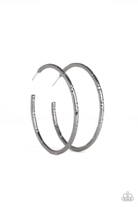 Etched in ribbons of diamond-cut shimmer, a shiny gunmetal hoop curls around the ear for a classic look. Earring attaches to a standard post fitting. Hoop measures 2 1/4" in diameter.  Sold as one pair of hoop earrings.