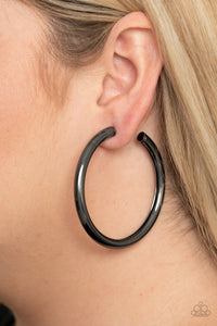 A thick gunmetal bar delicately curls into a glistening oversized hoop for a retro look. Earring attaches to a standard post fitting. Hoop measures approximately 2 1/4" in diameter.  Sold as one pair of hoop earrings.