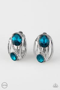 Encrusted in a section of radiant white rhinestones, glistening silver bars spin around two glittery blue rhinestones for a regal look. Earring attaches to a standard clip-on fitting. Sold as one pair of clip-on earrings.