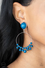 Load image into Gallery viewer, Shiny blue beads are threaded along a dainty wire hoop that attaches to an oversized blue beaded fitting, creating a bubbly fringe. Earring attaches to a standard clip-on fitting.  Sold as one pair of clip-on earrings.
