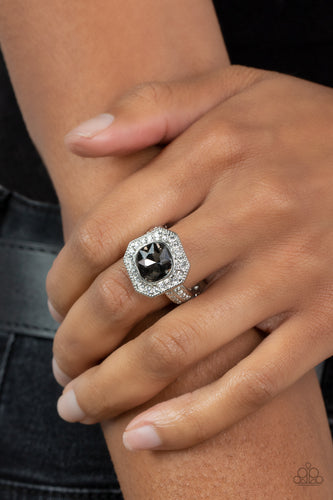 Bordered in a sparkly silver frame of glassy white rhinestones, an oversized smoky gem adorns the finger for a timeless finish. Features a dainty stretchy band for a flexible fit.  Sold as one individual ring.