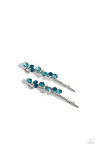 A bubbly cluster of light blue, dark blue, and iridescent rhinestones are encrusted across the front of a classic pair of silver bobby pins for an effervescent fashion.  Sold as one pair of decorative bobby pins.