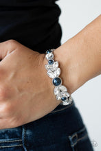 Load image into Gallery viewer, Dotted with bubbly blue pearls, an oversized collection of round and marquise style white rhinestones boldly coalesce into a sparkly centerpiece that is flanked by stacks of leafy silver frames that gracefully curve into a decorative cuff.  Sold as one individual bracelet.

