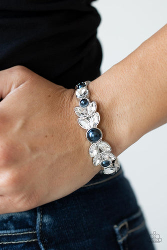Dotted with bubbly blue pearls, an oversized collection of round and marquise style white rhinestones boldly coalesce into a sparkly centerpiece that is flanked by stacks of leafy silver frames that gracefully curve into a decorative cuff.  Sold as one individual bracelet.