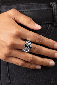 Bordered by two rows of dainty white rhinestones, an emerald cut Rhodonite rhinestone adorns the center of a band dotted in a pair of Spring Lake emerald cut rhinestones, resulting into a jaw-dropping dazzle across the finger. Features a stretchy band for a flexible fit.  Sold as one individual ring.