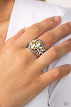 Load image into Gallery viewer, Bordered in dainty rows of glassy white rhinestones, leafy iridescent rhinestones bloom from a dramatically oversized iridescent rhinestone that coalesces into a glamorous centerpiece atop the finger. Features a stretchy band for a flexible fit. Due to its prismatic palette, color may vary.  Sold as one individual ring.
