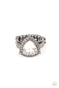 An oversized trilliant cut white rhinestone encased in a sparkling rhinestone-encrusted gunmetal frame steals the spotlight and creates an eye-catching stunner atop the finger. Features a dainty stretchy band for a flexible fit.  Sold as one individual ring.