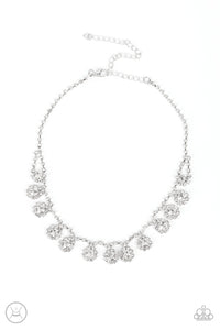 A dainty strand of glittery white rhinestones encircle solitaire white rhinestones around the neck, creating a glitzy fringe. Features an adjustable clasp closure.  Sold as one individual choker necklace. Includes one pair of matching earrings.
