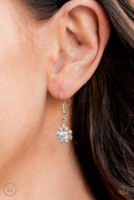 Load image into Gallery viewer, Dainty glittery white rhinestones encircle a solitaire white rhinestone, hanging from a silver fish hook earring.
