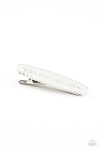 A classic collection of dainty white pearls is encased inside an oval acrylic frame, creating a refined centerpiece atop a silver hair clip. Features a standard hair clip on the back.  Sold as one individual hair clip.