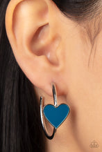 Load image into Gallery viewer, A charming Mykonos Blue heart adorns the front of a classic silver hoop resulting in a whimsical fashion. Earring attaches to a standard post fitting. Hoop measures approximately 1 1/4&quot; in diameter.  Sold as one pair of hoop earrings.
