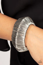 Load image into Gallery viewer, Layer after layer of glistening silver wire wraps around an oversized silver cuff. The center of the wire wrap comes to a peak, adding edge to the intense industrial display.  Sold as one individual bracelet.
