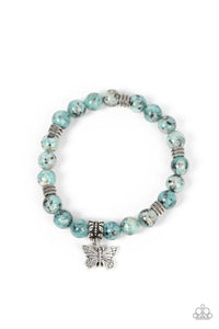Infused with a silver butterfly charm, textured silver accents and black speckled blue stone beads are threaded along stretchy bands around the wrist for a whimsical look.  Sold as one individual bracelet.