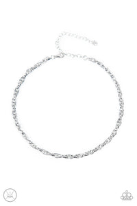 An ornately linked silver chain wraps around the neck, resulting in an edgy minimalist inspired grit. Features an adjustable clasp closure.  Sold as one individual choker necklace. Includes one pair of matching earrings.