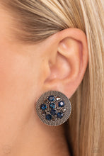 Load image into Gallery viewer, A glitzy collection of blue and hematite rhinestones are encircled with a silver rope-like border, resulting in a smoldering centerpiece. Earring attaches to a standard clip-on earrings.  Sold as one pair of clip-on earrings.
