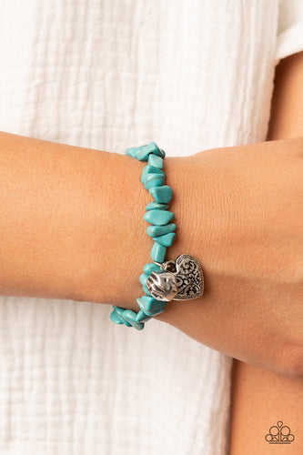 Infused with a hammered silver bead and a decorative silver heart charm, an earthy collection of turquoise pebbles are threaded along a stretchy band around the wrist for a whimsical fashion.  Sold as one individual bracelet.