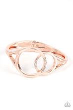 Load image into Gallery viewer, Encrusted in sections of glassy white rhinestones, two oversized rose gold rings delicately overlap across the center of the wrist, resulting in a timeless bangle-like bracelet around the wrist. Features a hinged closure.  Sold as one individual bracelet.
