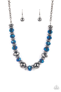 A dramatic assortment of oversized gunmetal beads, textured gunmetal rings, and faceted metallic blue gems delicately glides along an invisible wire below the collar, resulting in a stellar sparkle. Features an adjustable clasp closure. Includes one pair of matching earrings.