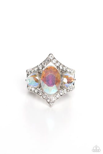 An oversized iridescent oval gem is flanked by a pair of iridescent teardrop rhinestones atop a white rhinestone dotted frame, resulting in a dramatic dazzle atop the finger. Features a stretchy band for a flexible fit. Due to its prismatic palette, color may vary.  Sold as one individual ring.
