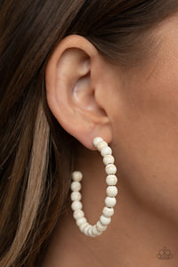 Earthy white stone beads are threaded along a dainty wire hoop, resulting in an earthy flair. Earring attaches to a standard post fitting. Hoop measures approximately 2" in diameter.  Sold as one pair of hoop earrings.