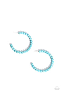 Refreshing turquoise stone beads are threaded along a dainty wire hoop, resulting in an earthy flair. Earring attaches to a standard post fitting. Hoop measures approximately 2" in diameter.  Sold as one pair of hoop earrings.