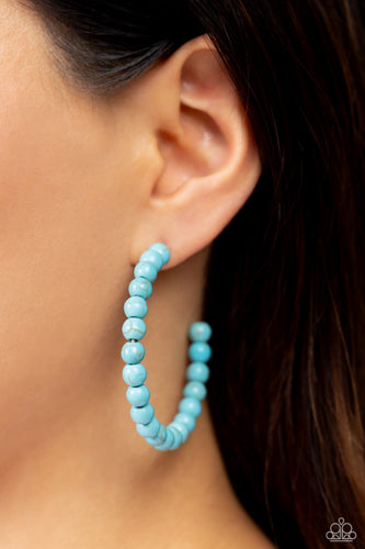 Refreshing turquoise stone beads are threaded along a dainty wire hoop, resulting in an earthy flair. Earring attaches to a standard post fitting. Hoop measures approximately 2