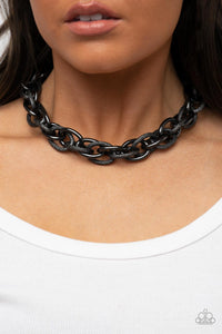 Featuring smooth and glitzy textured finishes, two oversized gunmetal chains interlock into a single chain below the collar for an intense industrial display. Features an adjustable clasp closure.  Sold as one individual necklace. Includes one pair of matching earrings.