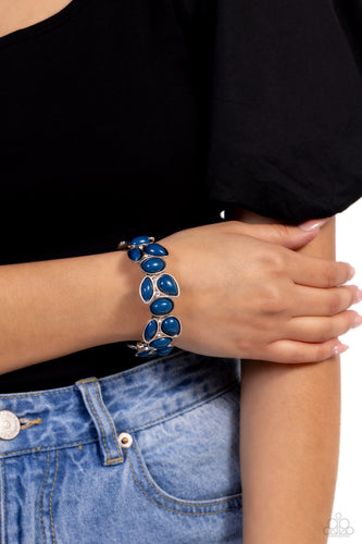 Glassy white rhinestones are sprinkled between bubbly clusters of Mykonos Blue oval, teardrop, and marquise shaped beads that are threaded along stretchy bands around the wrist for a colorfully leafy finish. Sold as one individual bracelet.