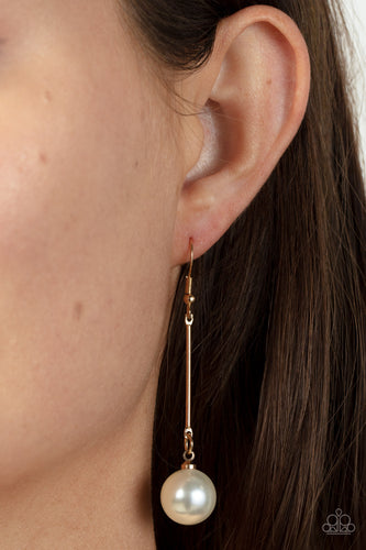 An oversized white pearl delicately links to the bottom of a sleek gold rod, adding a timeless twist to the classic pearl palette. Earring attaches to a standard fishhook fitting.  Sold as one pair of earrings.