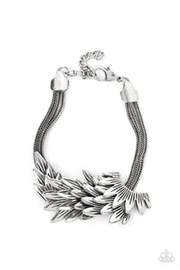 Feathery silver frames delicately overlap across the center of the wrist, creating a boa-like centerpiece atop rows of rustic silver chains. Features an adjustable clasp closure.  Sold as one individual bracelet.