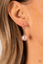 Load image into Gallery viewer, Small pink pearl hanging from a silver fish hook earring.
