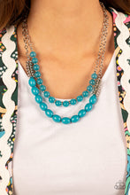 Load image into Gallery viewer, Infused with silver accents, rows of glassy and acrylic blue beads are threaded along invisible wires at the bottom of two silver chains that layer into a vivacious pop of color below the collar. Features an adjustable clasp closure.  Includes one pair of matching earrings.
