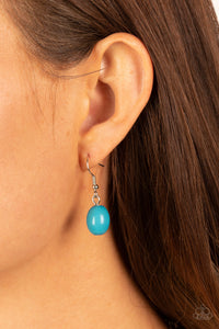 Blue bead hanging from a silver fish hook earring.