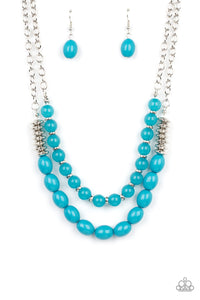 Infused with silver accents, rows of glassy and acrylic blue beads are threaded along invisible wires at the bottom of two silver chains that layer into a vivacious pop of color below the collar. Features an adjustable clasp closure.  Includes one pair of matching earrings.