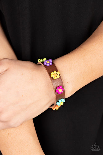 Multicolored beads bloom into vivacious flowers across the front of a brown leather band, bursting into a colorful floral accent. Features an adjustable sliding knot closure.  Sold as one individual bracelet.