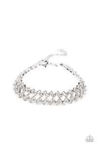 Set in pronged silver settings, pairs of icy white rhinestones haphazardly stack around the wrist in sizzling rows of shimmer. Features an adjustable clasp closure.  Sold as one individual bracelet.