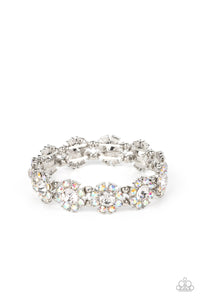 Separated by pairs of dainty silver beads, iridescent rhinestone dotted petals bloom from oversized white rhinestone centers along stretchy bands around the wrist for a flirtatious floral fashion. Due to its prismatic palette, color may vary.  Sold as one individual bracelet.
