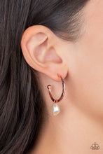 Load image into Gallery viewer, An imperfect white pearl glides along a hammered shiny copper hoop, creating a timeless twist. Earring attaches to a standard post fitting. Hoop measures approximately 1&quot; in diameter.  Sold as one pair of hoop earrings.
