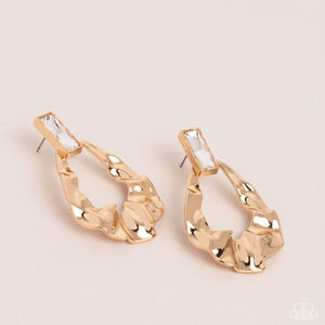 Folds of warped gold delicately gather into an edgy teardrop at the bottom of an emerald cut white rhinestone. Earring attaches to a standard post fitting.  Sold as one pair of post earrings.