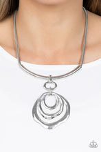 Load image into Gallery viewer, Warped silver hoops glisten from the bottom of a bowing silver bar set in the center of a rounded silver snake chain, resulting in a contemporary centerpiece below the collar. Features an adjustable clasp closure.  Sold as one individual necklace. Includes one pair of matching earrings.
