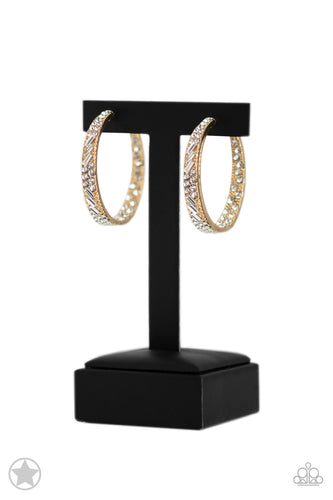 The front-facing surface of a chunky gold hoop is dipped in brilliantly sparkling white rhinestones while light-catching texture wraps around the back. The interior of the hoop features the opposite pattern, creating the illusion of a full hoop of blinding Blockbuster rhinestones. Earring attaches to a standard post fitting. Hoop measures 1 3/4