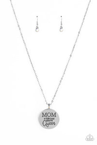 At the bottom of a shiny silver chain, a shiny silver disc is stamped with the phrase, "MOM a title just above Queen." The clasp attaching the disc to the chain features a collection of dainty iridescent rhinestones, adding a hint of sparkle to the sentimental statement piece. Features an adjustable clasp closure. Due to its prismatic palette, color may vary.  Sold as one individual necklace. Includes one pair of matching earrings.