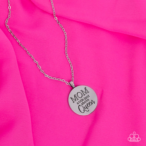 At the bottom of a shiny silver chain, a shiny silver disc is stamped with the phrase, 