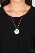 Load image into Gallery viewer, At the bottom of a shiny silver chain, a shiny silver disc is stamped with the phrase, &quot;MOM a title just above Queen.&quot; The clasp attaching the disc to the chain features a collection of dainty iridescent rhinestones, adding a hint of sparkle to the sentimental statement piece. Features an adjustable clasp closure. Due to its prismatic palette, color may vary.  Sold as one individual necklace. Includes one pair of matching earrings.
